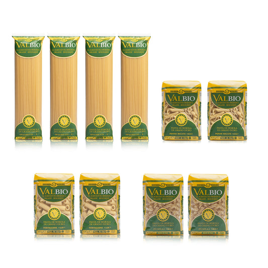 Assortimento di pasta biologica Valbio in confezioni da 500g: quattro pacchi di spaghetti, due di penne rigate, una di tortiglioni e tre di fusilli, disposti su sfondo bianco.